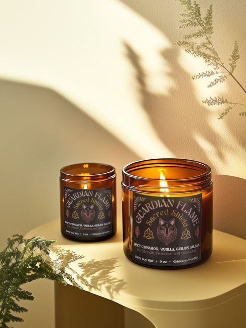 Amber glass jar with Guardian Flame label featuring a metallic wolf and flame motifs in pink and gold. Spicy cinnamon, vanilla, and gurjun balsam candle. 9 oz soy candle by Grimoire & Goblet.